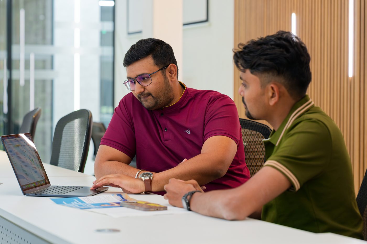 NexAura founders reviewing an edit on a laptop
